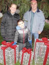 Alice and Mike Nuzzolese with one of their grandsons, Daniel, at the holiday display in downtown Goshen.