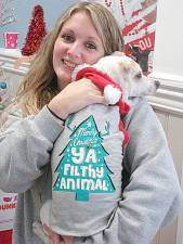 Minnie, a chihuahua mix, contently snuggles in the arms of Jerrica Figuerola, a worker at the Goshen shelter.