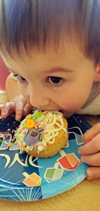 Owen Besson of Chester digs into his Chanukah themed cupcake that he decorated at Chabad’s Chanukah Tot Party, led by Chana Burston.