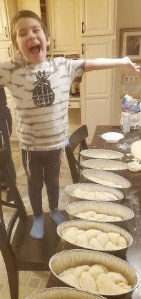 Kovy Burston, 5, of Monroe helps his mom, Chana Burston, make the challah for the “Chocolate Challah for the Quarantined Soul” care packages from Chabad.