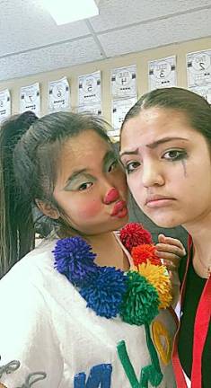 Jolina Dong, who played a clown, left, with teammate Naima Puertas, who played a sad ribbon dancer in their circus skit.