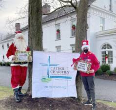 Pictured from left to right: Santa’s helpers Dylan Holder and James Foley greeted guests participating in Catholic Charities’ 2020 Goshen Christmas House Tour “Lights! Around Town” as they arrived at the Stagecoach Inn. Provided photos.