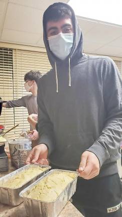 CTeen member Gavin Reich is pictured with the loaves of Beer Bread he made at the CTeen “Pies of Thanks Thanksgiving” event.