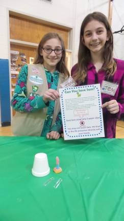 A fun night for science and math Saving Sam: Carly Weinberger and Lindsey Boschetti help others with the game to save Sam