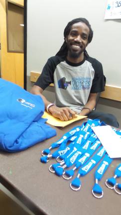 A movement grows to protect vulnerable immigrants Aaron Jones, mass engagement director of CVH (Community Voices Heard), sells CVH items at the Newburgh Armory (Photo by Frances Ruth Harris)