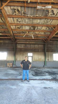 Town of Chester Highway Superintendent Anthony La Spina standing in one of the bays damaged in last April's fire at the highway department garage.
