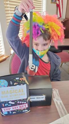 Landon Godenberg of Warwick learns about the Mah Nishata – The Four Questions asked at the Seder table – with a fun “Mah Nisthana Magic” workshop at Chabad Hebrew School.