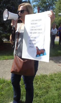 Farm owner accused in horses' deaths case may face felony charge Maryanne Zambrzycki spoke up on a mega phone with a siren (Photo by Frances Ruth Harris)