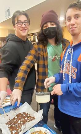 Conner Ingber of Goshen, Arlo Steir of Monroe and Jared Pincus of Florida, NY work together to create Artisanal Chocolate Bark for Police at CTeen’s “Chocolates for Cops” at the Chabad Center in Chester