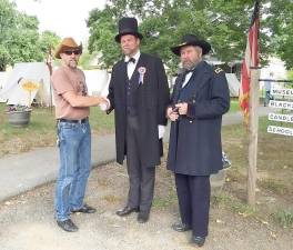 Mike Sosler, the soon to be former executive director of Museum Village in Monroe, stepped back in time during a Civil War reenactment to share a moment with President Abraham Lincoln and General Ulysses S. Grant. Imagine that conversation. Provided photo.