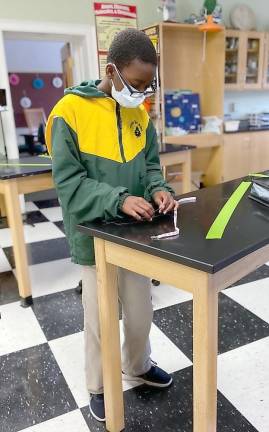 In an effort led by sixth-grade advisor and math teacher Melissa Leventhal, Tuxedo Park School students are hand-stitching mask strings marked with pink ribbons. They have designed a marketing plan and are selling the strings to raise money for Breast Cancer Research. Provided photos.