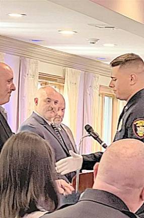 Ptl. Glick is presented his certificate by his father, Michael, a veteran of the New York Air National Guard 105th Airlift Wing