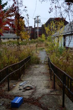 Camp LaGuardia at the crossroads Overgrown grounds, a walkway to nowhere, a still-standing utility pole and several outbuildings at the back of Camp LaGuardia. Courtesy of Robert Yasinsac / Hudson Valley Ruins.