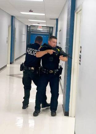 Village of Goshen Police Officers trained in tactical entry in the classroom wings of Goshen High School.