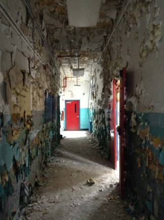 Camp LaGuardia at the crossroads A hallway of ruins, almost artistic in its starkness, ends at a red door that leads to nowhere on the first floor of the main building of Camp LaGuardia in this 2013 photograph. Courtesy of Robert Yasinsac and his website, Hudson Valley Ruins.