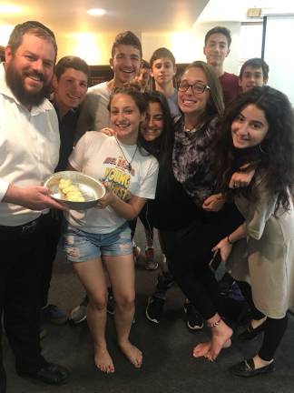 Chabad’s CTeen Cares Program spreads community kindness CTeen Cares participants, pictured with Rabbi Pesach, proudly braided challah to be distributed to community members in need (Photo provided)