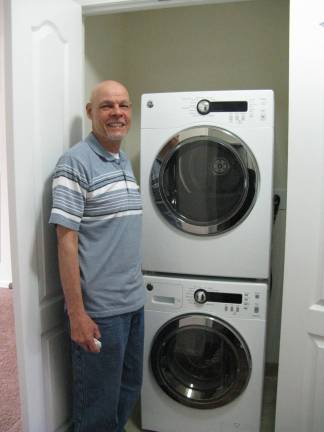 New beginnings at Meadow Hills Victor Gonzales is pleased with his new washer and dryer (Photo by Ginny Privitar)