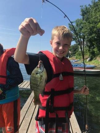Sheriff DuBois sends local kids to summer camp Campers go fishing