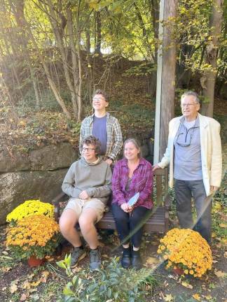 Garden bench donated by Steris in honor of Ellen Shortess. Standing, Ellen’s grandson Oakley Smith and widower Stephen Shortess. Seated, grandson Odin Smith and Micki Smith, daughter of Ellen and Stephen Shortess.