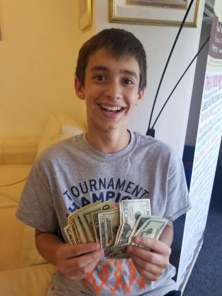 Chabad’s CTeen Cares Program spreads community kindness Ben Cohen of Highland Mills counts the proceeds from the charity car wash to benefit pediatric cancer patients (Photo provided)