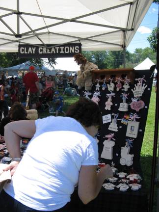 Great American Weekend brings on the crowds A visitor examines the wonderful items at Clay Creations.