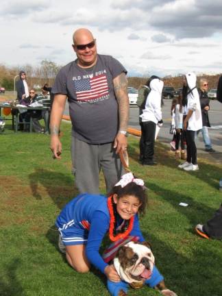 Chester celebrates the haunting season Cheerleaders Adriana Caop, dad Ernie, and dog Brutus, 2, of Chester (Photo by Ginny Privitar)