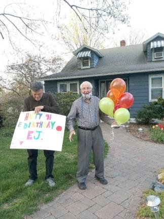 E.J. Szulwach loved his surprise birthday party on March 28th. Richard Robillard held the sign.