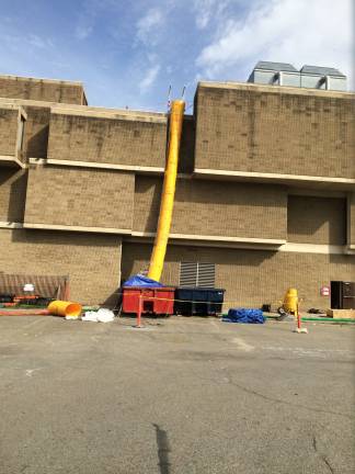 Asbestos removal underway at government center The yellow chute facilitates asbestos removal at the government center. (Photo by Edie Johnson)