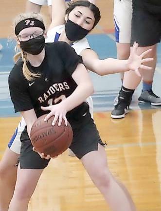 Junior Janelle Lopez (in white uniform) on defense.