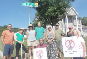 Creamery Pond residents protesting the cell tower are pictured, from left to right: Edgar Vallejo, Ellen Korsower, Alex O’Brien, Bill O’Brien, Karen Campbell, Robert Campbell, John Grybowski, Donna Howihan, and Lydia Cuadros. Photo by Frances Ruth Harris.