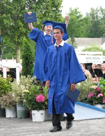 Goshen's Class of 2014 Sean Anderson shows his exhilaration, while Jonathan Perrego holds still for a photographer.