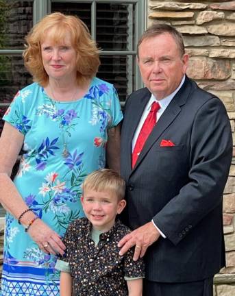 Marie and James Osborne with one of their grandchildren. James Osborne was recently elected to the New York State Public High School Athletic Association’s Hall of Fame.