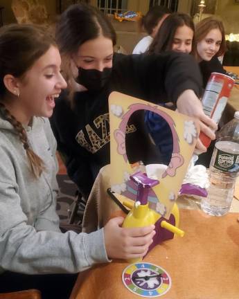 Teens have a great time playing “Pie Face” at the CTeen Thanksgiving cook-off at Chabad of Orange County.