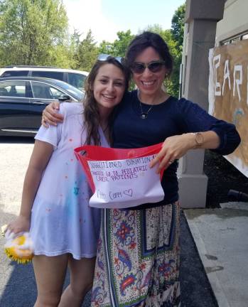 Chabad’s CTeen Cares Program spreads community kindness CTeen leader Shaina Steir (left) collects funds for charity at the charity car wash. She stands next to Chana Burston (Photo provided)