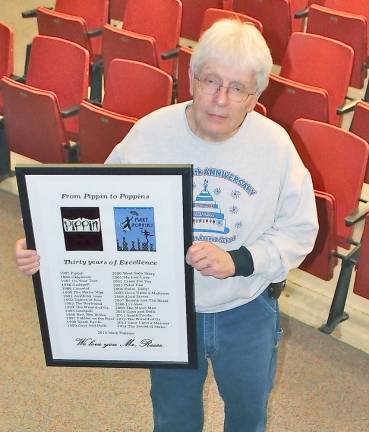 Roy Reese displays the picture given to him by the cast and crew of Mary Poppins commemorating his first 30 spring musicals.