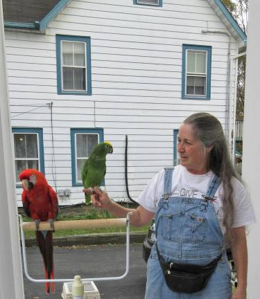 A blessing for Princess Buttercup, and other bright creatures Pat Rose of Sugar Loaf with Ms. Charlotte (left), a Scarlet macaw, and Frankie, a yellow-crowned Amazon (Photo by Ginny Privitar)