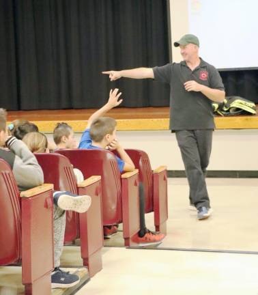 Firefighter Matteo Cirigliano speaks to fifth graders at Goshen Intermediate School.