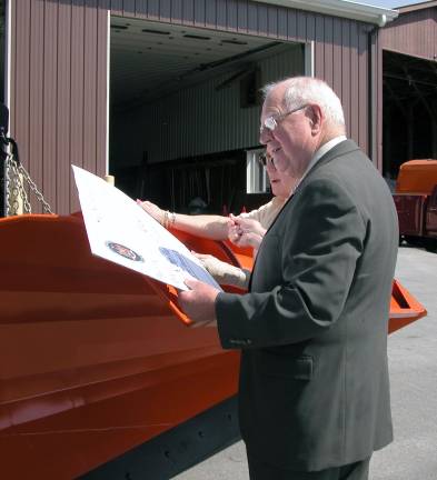 Senator William Larkin in 2006 signs a presentation check for $75,000 that helped purchase