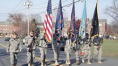 The Color Guard for Goshen Veterans of Foreign Wars Post 1708 and Goshen American Legion Post 377 led by Commander Ray Quattrini (left) march up North Church Street in the Village of Goshen.