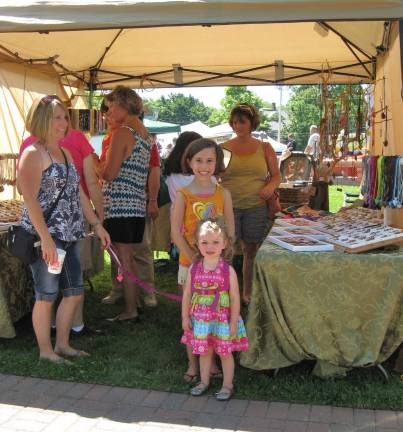 Scenes from Great American Weekend Mom Stacy Freiberger, far left, and daughters Avaree Noelle (yellow shirt) and Addison (pink dress) of Goshen admired jewelry at this stall.
