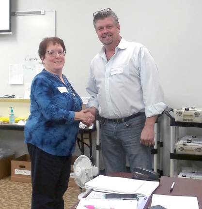 Sue Bahren congratulates Bob Valentine on his victory at the ballot counting at the Orange County Board of Elections in Goshen.