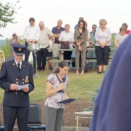 Ed Stoddard, memorial organizer, and The Rev. Erin Moore as she gives the welcoming prayer.