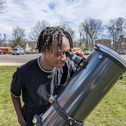 C.J. Hooker Middle School students view the solar eclipse through a telescope with a solar filter.