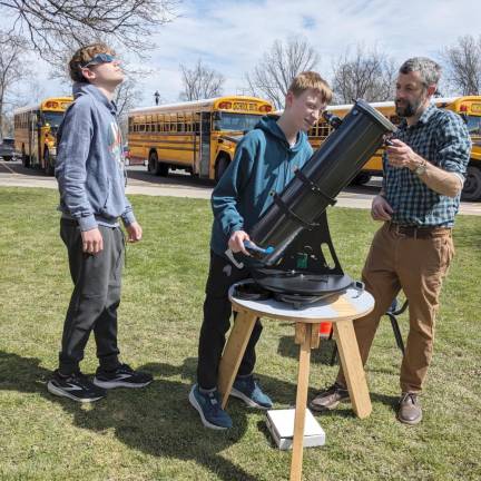 C.J. Hooker Middle School students view the solar eclipse through a telescope with a solar filter.