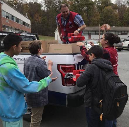 Victoria and Paulie, managers at the Middletown Lowe’s, unload tools and supplies that Goshen’s Science Olympiad will use to prepare for this year’s regional and state competitions.