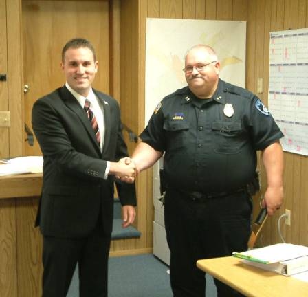 Chester Village Board briefs Photo courtesy Detective Timothy McGuire Police Chief Peter Graziano congratulates a new full-time officer, Luke Fremgen.
