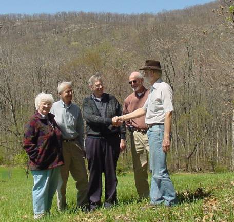 25 years of land conservation Provided photo Some of the Orange County Land Trust’s founding board members are featured in a photo with conservation easement landowner and supporter Stanley Kocot. In April 2003, 51 acres of forested habitat on Mount Eve were protected through a conservation easement between Kocot and the Land Trust. The property is contiguous with other lands already conserved by the organization. Pictured from left to right are: founding board member Elmire Conklin, founder and former County Executive, the late Louis Mills, Stanley Kocot, former board president, the late Dr. Douglas McBride and John Gebhards, the first Executive Director.