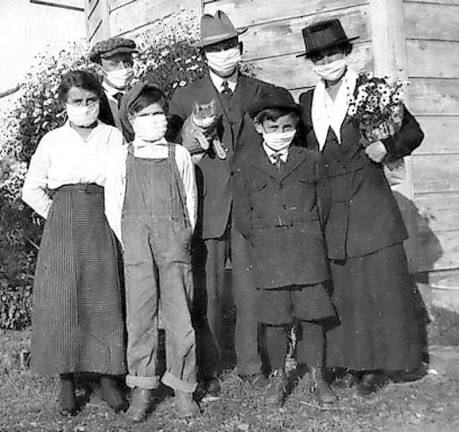 Then and now A masked family and their cat.