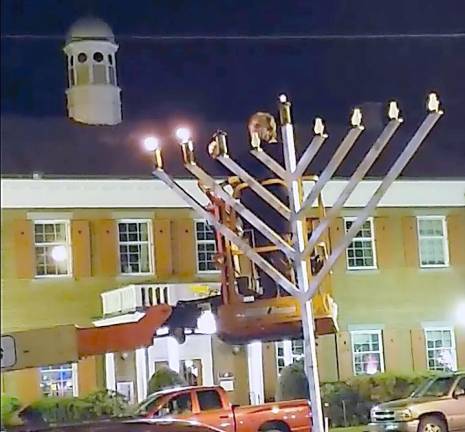 Jerry Goldstein of Goshen lighting the menorah last year in Goshen.