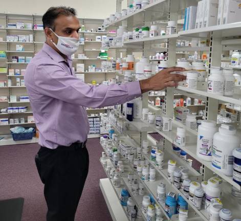 Pharmacist Samir Shah at K&amp;K Pharmacy, which he owns with his wife, Hetal.